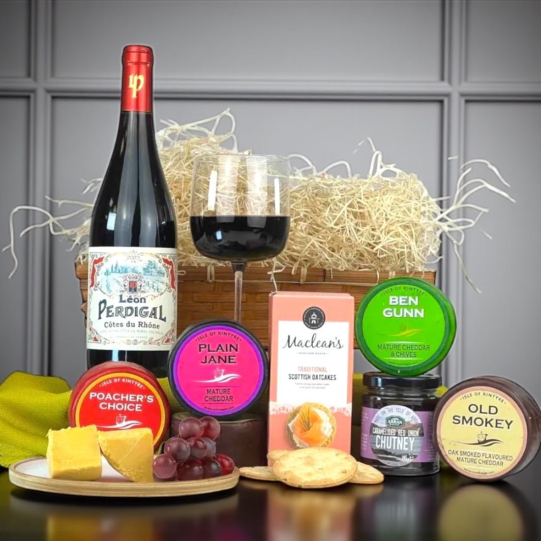 Scottish cheese hamper with a wine bottle, labelled cheese truckles, oatcakes and chutney